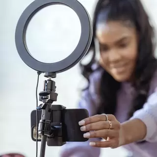 A social media influencer sets up a ring light
